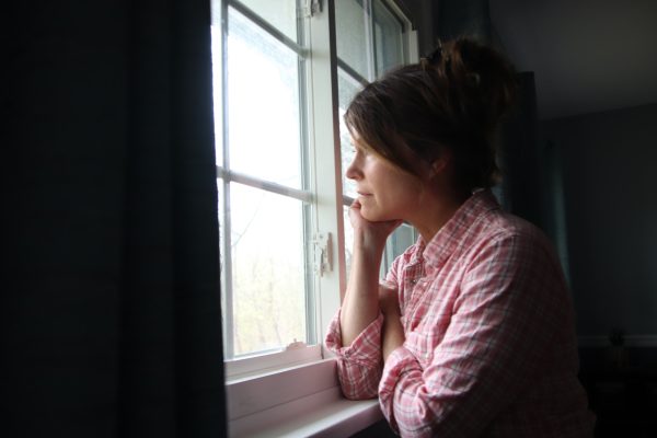Sad woman looking out window- NOMINATED-